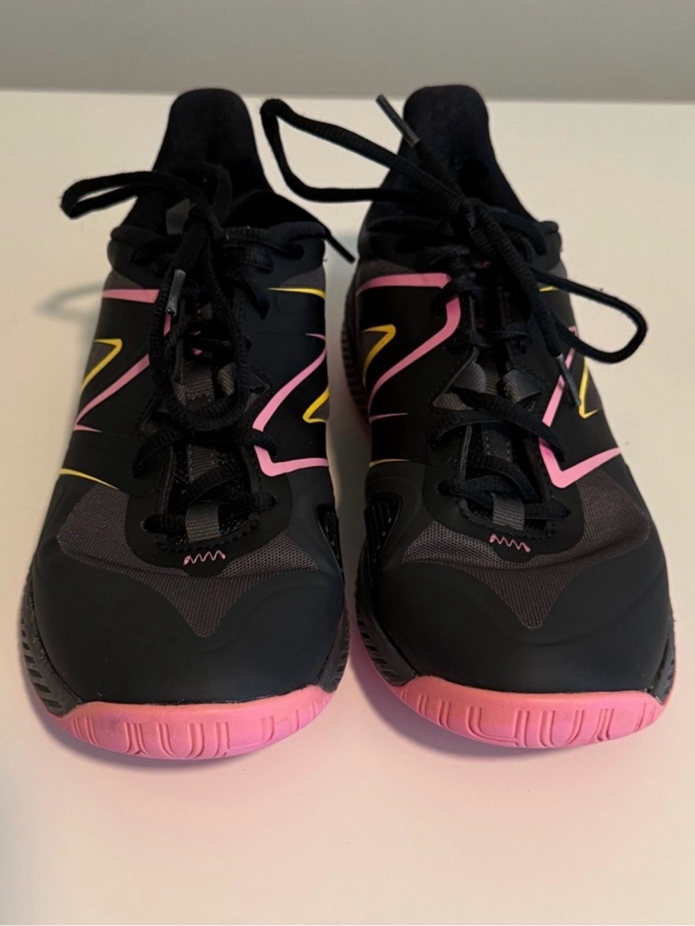 New Balance Black Athletic Shoes with Pink and Yellow Accents